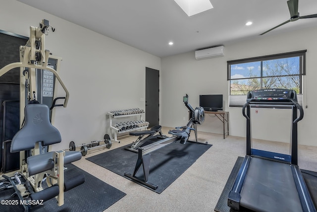 exercise room featuring recessed lighting, a wall unit AC, and a skylight