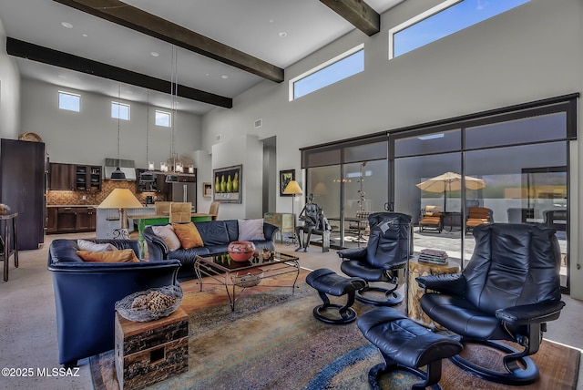 living area with a high ceiling and beam ceiling
