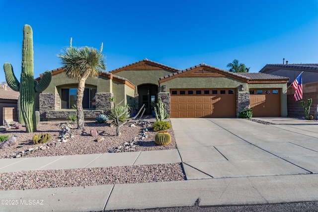 view of front of home featuring an attached garage, stucco siding, stone siding, and concrete driveway