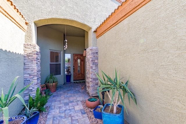 property entrance with stucco siding