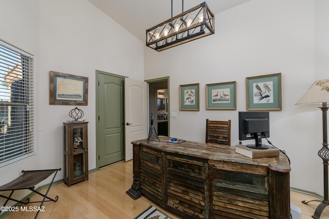 office featuring light wood-type flooring and high vaulted ceiling