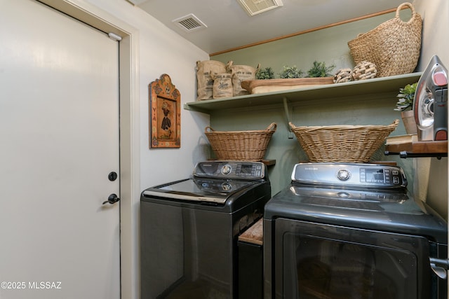clothes washing area featuring laundry area, separate washer and dryer, and visible vents