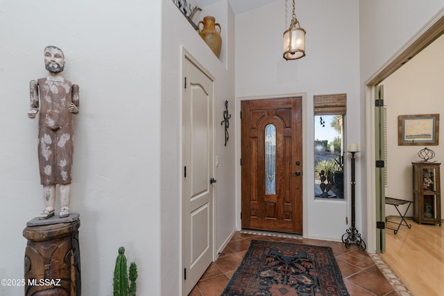 tiled foyer featuring a towering ceiling
