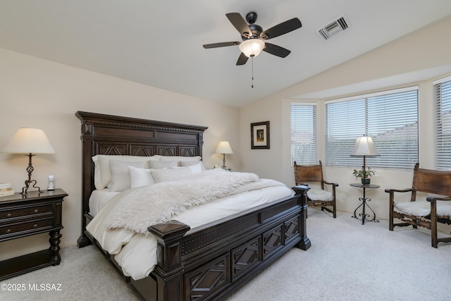bedroom featuring light colored carpet, a ceiling fan, visible vents, and vaulted ceiling