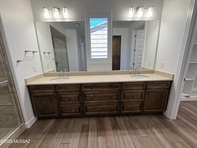 66414 E Peregrine Pl, Tucson, AZ 85739 - full bath with wood finished floors, double vanity, and a stall shower