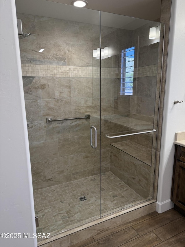 66414 E Peregrine Pl, Tucson, AZ 85739 - full bathroom with wood finished floors, vanity, and a shower stall