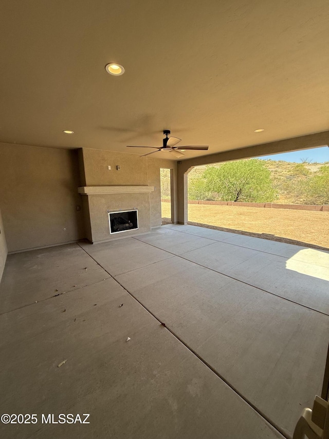 66414 E Peregrine Pl, Tucson, AZ 85739 - view of patio / terrace with ceiling fan and a fireplace