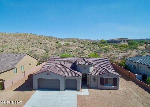 66414 E Peregrine Pl, Tucson, AZ 85739 - mediterranean / spanish-style home with a garage, driveway, stucco siding, and a tiled roof