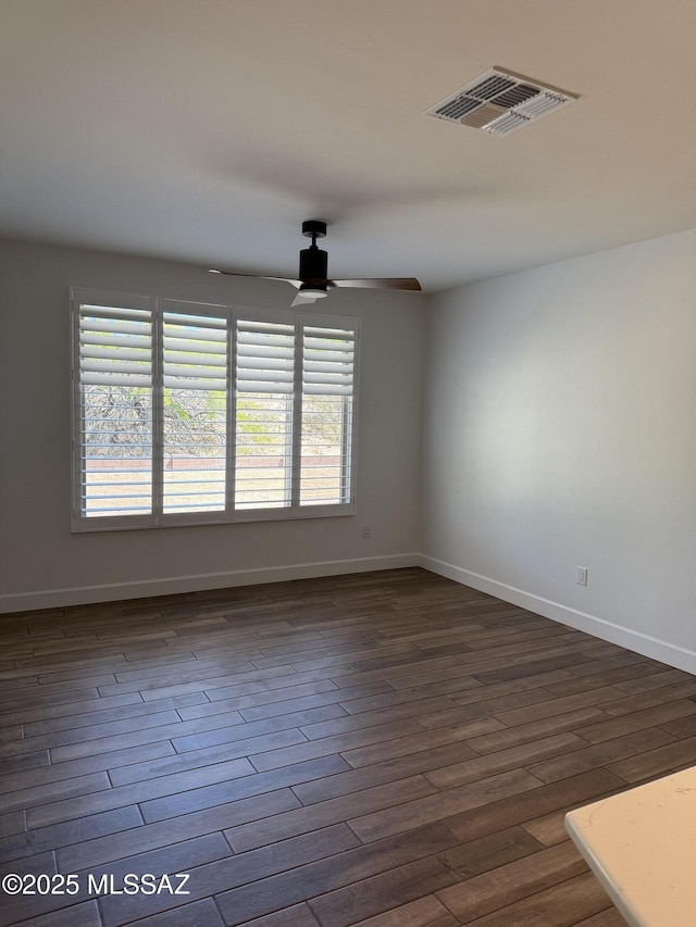 66414 E Peregrine Pl, Tucson, AZ 85739 - spare room featuring a ceiling fan, dark wood-style flooring, and baseboards
