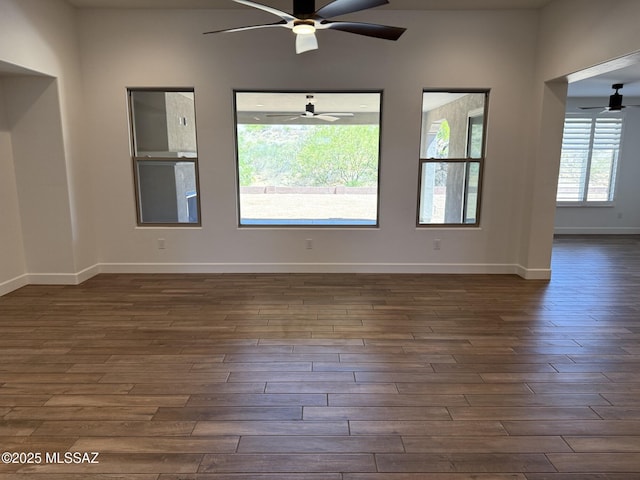 66414 E Peregrine Pl, Tucson, AZ 85739 - empty room with a ceiling fan, dark wood-style floors, and baseboards