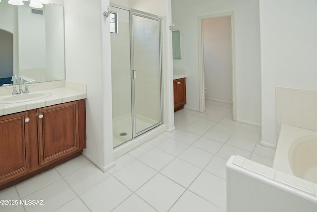 bathroom with vanity, a stall shower, a bath, and visible vents