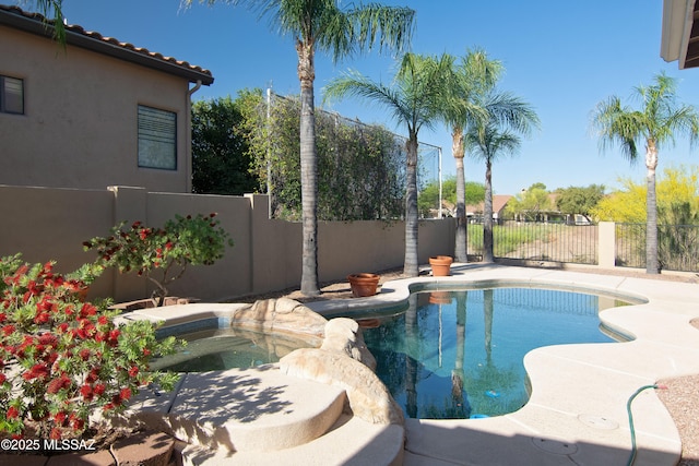 view of pool featuring a fenced backyard, a fenced in pool, and an in ground hot tub