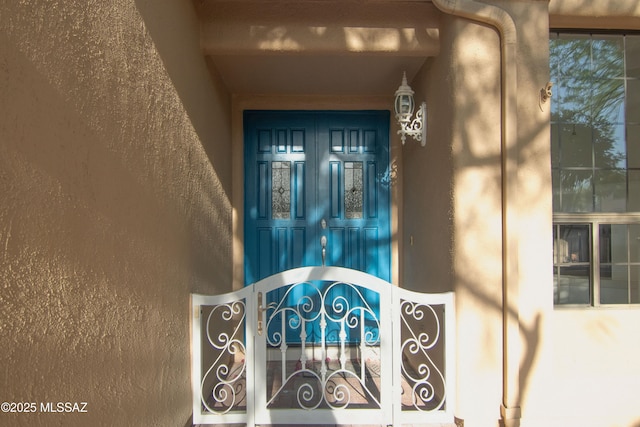 view of exterior entry with stucco siding