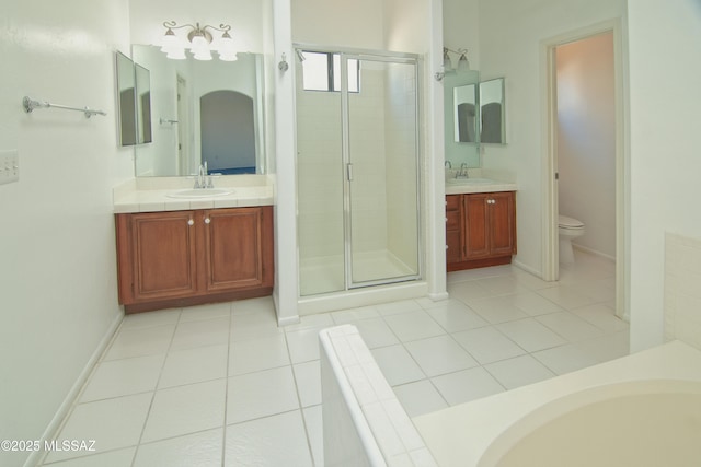bathroom featuring vanity, toilet, and a shower stall