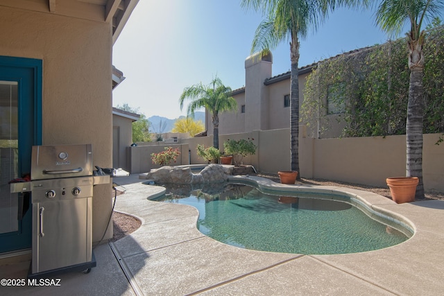 view of pool featuring a grill, a patio, a fenced backyard, a fenced in pool, and a hot tub