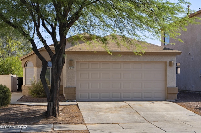 4249 E Cholla Desert Trl, Tucson, AZ 85706 - view of front facade featuring stucco siding, concrete driveway, and an attached garage