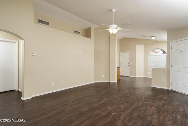 4249 E Cholla Desert Trl, Tucson, AZ 85706 - spare room with ceiling fan, dark wood-style flooring, arched walkways, vaulted ceiling, and baseboards