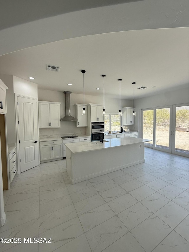 kitchen with recessed lighting, wall chimney exhaust hood, marble finish floor, visible vents, and double oven