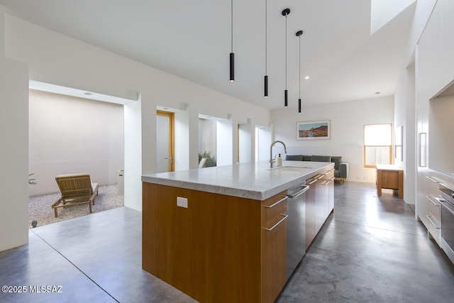 kitchen featuring a sink, modern cabinets, brown cabinets, a spacious island, and open floor plan