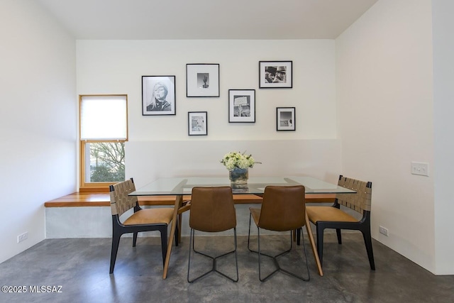 dining space featuring finished concrete flooring