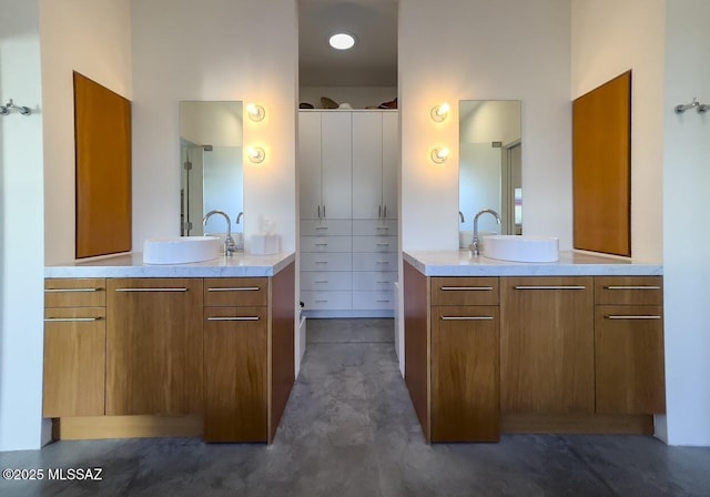 bathroom featuring two vanities and a sink
