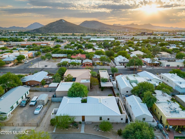 aerial view at dusk featuring a residential view and a mountain view