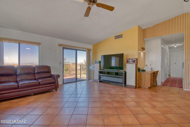4050 S Melpomene Way, Tucson, AZ 85730 - living area featuring a textured ceiling, visible vents, light tile patterned floors, and lofted ceiling