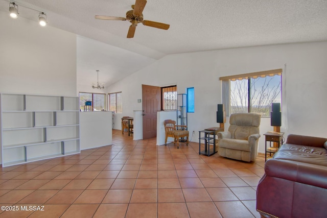 4050 S Melpomene Way, Tucson, AZ 85730 - living area featuring a textured ceiling, ceiling fan with notable chandelier, light tile patterned floors, and lofted ceiling