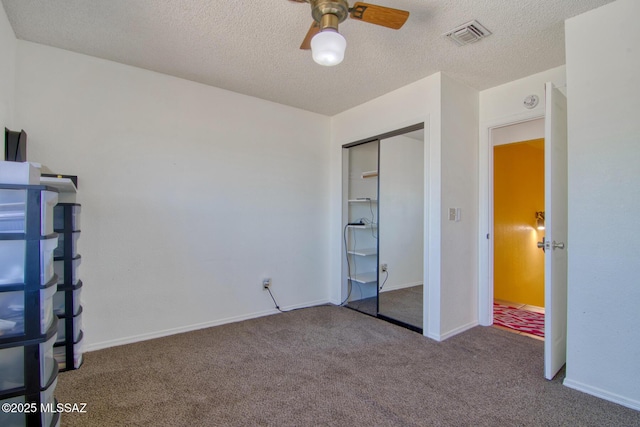 4050 S Melpomene Way, Tucson, AZ 85730 - unfurnished bedroom featuring carpet, a closet, a textured ceiling, and visible vents