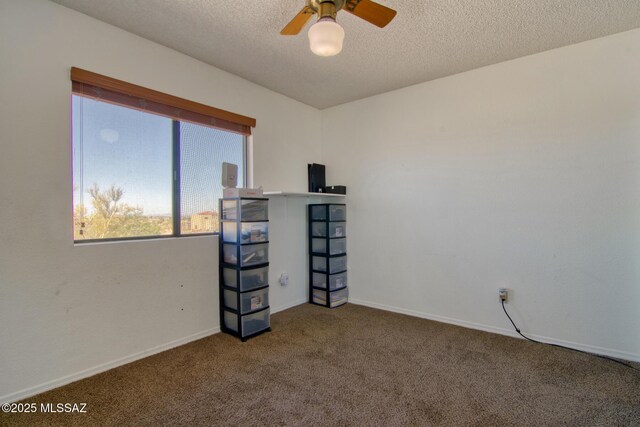 4050 S Melpomene Way, Tucson, AZ 85730 - spare room featuring carpet flooring, a ceiling fan, a textured ceiling, and baseboards