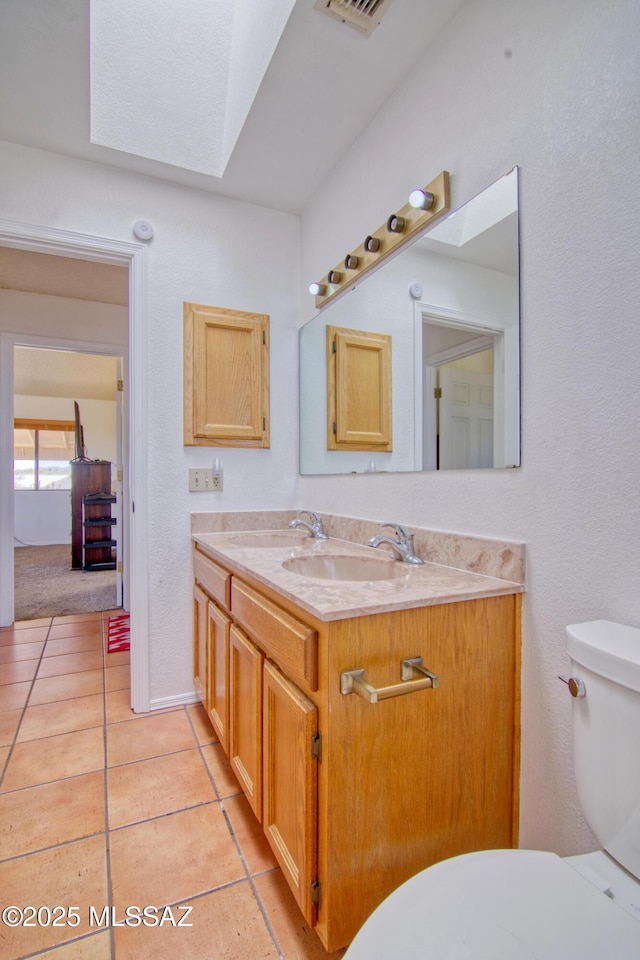 4050 S Melpomene Way, Tucson, AZ 85730 - half bath featuring vanity, tile patterned floors, visible vents, and toilet