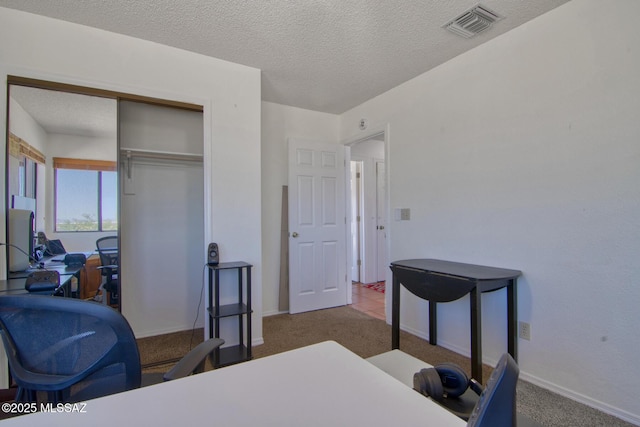 4050 S Melpomene Way, Tucson, AZ 85730 - carpeted bedroom with baseboards, a closet, a textured ceiling, and visible vents