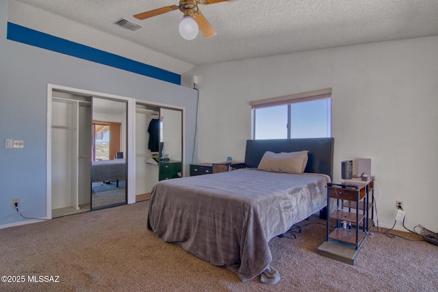 4050 S Melpomene Way, Tucson, AZ 85730 - bedroom featuring a textured ceiling, multiple closets, carpet, a ceiling fan, and visible vents