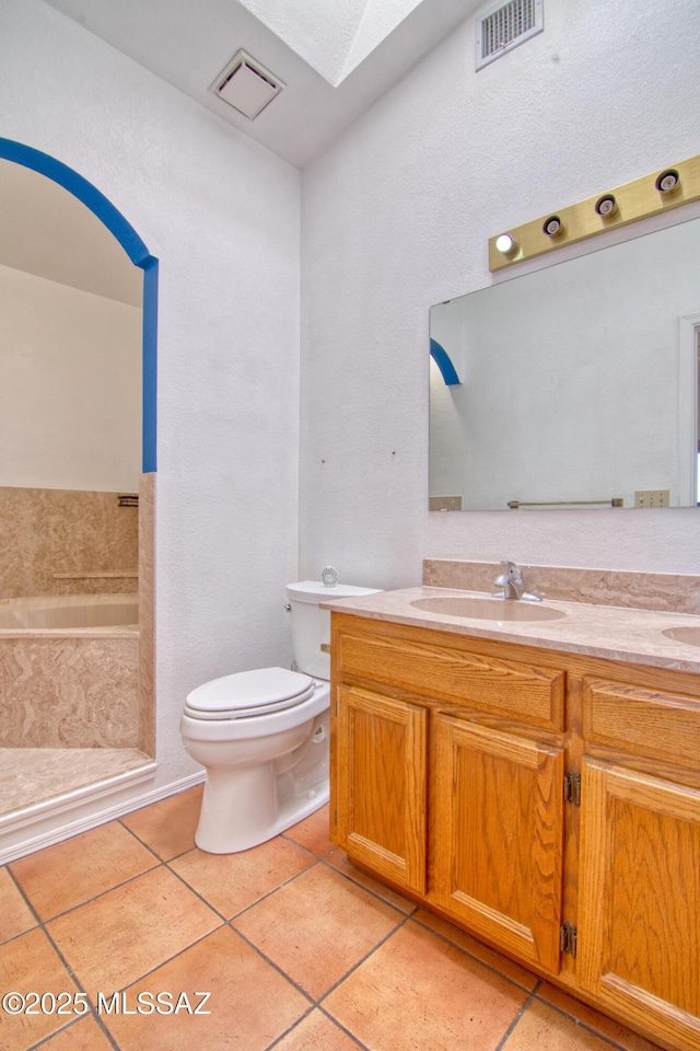 4050 S Melpomene Way, Tucson, AZ 85730 - bathroom with visible vents, a skylight, tile patterned flooring, a sink, and toilet