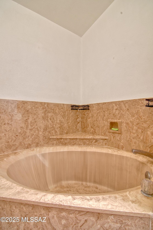 4050 S Melpomene Way, Tucson, AZ 85730 - bathroom with a tub and vaulted ceiling