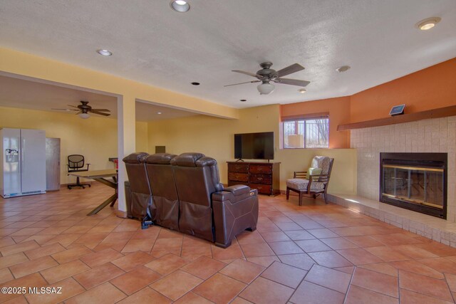4050 S Melpomene Way, Tucson, AZ 85730 - living room featuring a fireplace, a ceiling fan, and recessed lighting