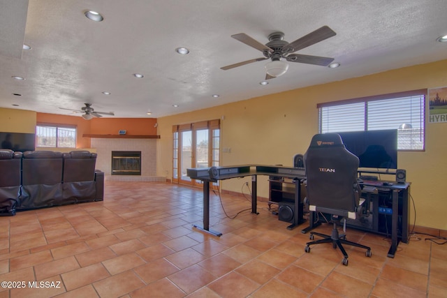 4050 S Melpomene Way, Tucson, AZ 85730 - tiled office with a textured ceiling, a ceiling fan, recessed lighting, and a tile fireplace