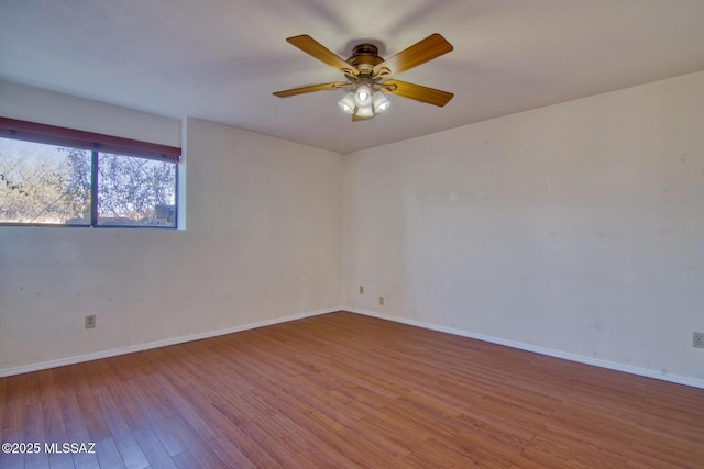 4050 S Melpomene Way, Tucson, AZ 85730 - spare room with a ceiling fan, baseboards, and wood finished floors