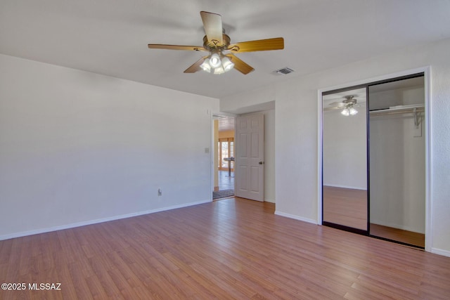 4050 S Melpomene Way, Tucson, AZ 85730 - unfurnished bedroom with baseboards, ceiling fan, a closet, and light wood-style flooring