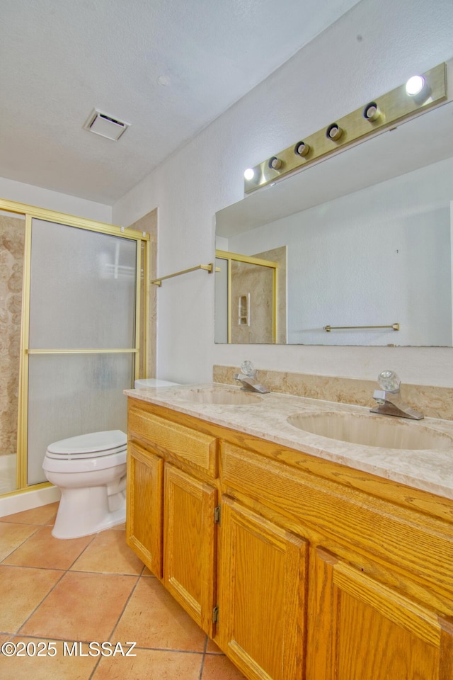 4050 S Melpomene Way, Tucson, AZ 85730 - bathroom featuring double vanity, a sink, toilet, and a shower stall