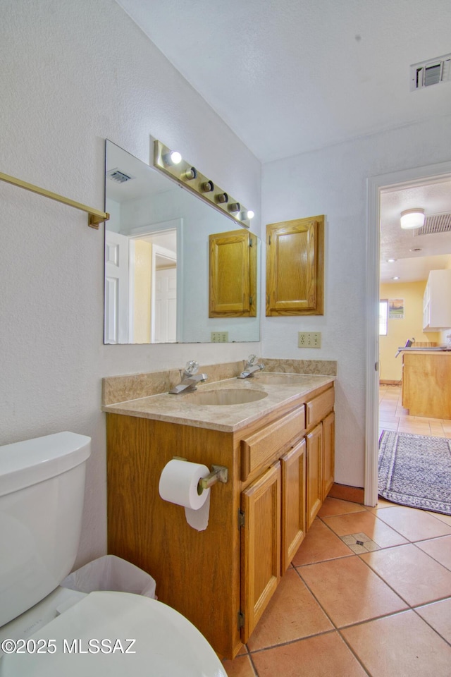 4050 S Melpomene Way, Tucson, AZ 85730 - bathroom with toilet, tile patterned floors, visible vents, and vanity