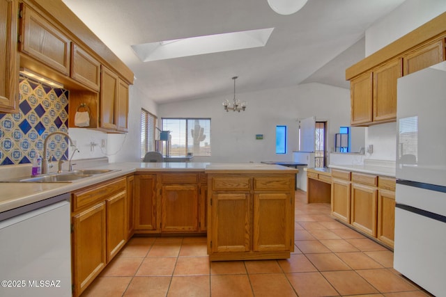 4050 S Melpomene Way, Tucson, AZ 85730 - kitchen featuring a peninsula, white appliances, light countertops, a sink, and a notable chandelier