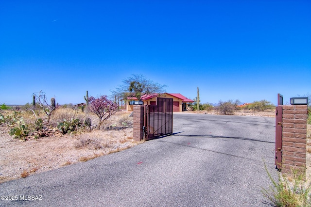 4050 S Melpomene Way, Tucson, AZ 85730 - view of road with a gated entry, a gate, and aphalt driveway