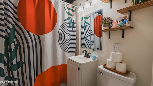 bathroom featuring vanity, toilet, and a shower with shower curtain