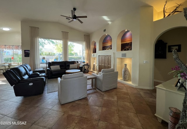 living area with baseboards, a ceiling fan, and high vaulted ceiling