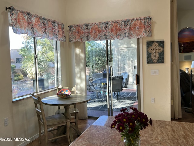 dining area featuring a healthy amount of sunlight and tile patterned flooring