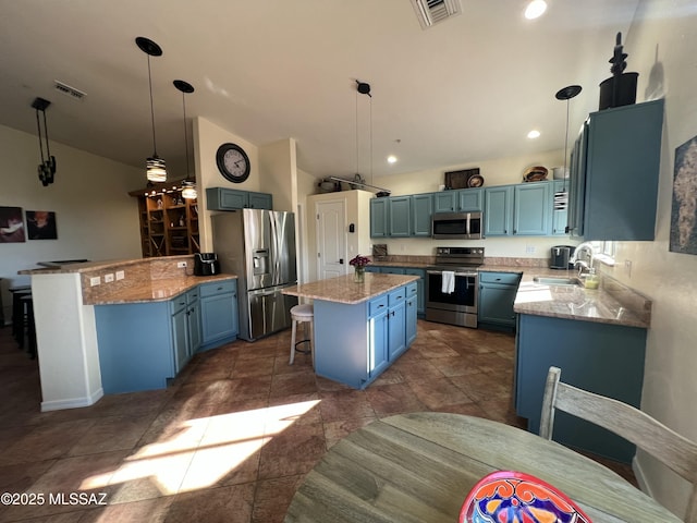kitchen featuring visible vents, a sink, appliances with stainless steel finishes, and blue cabinetry