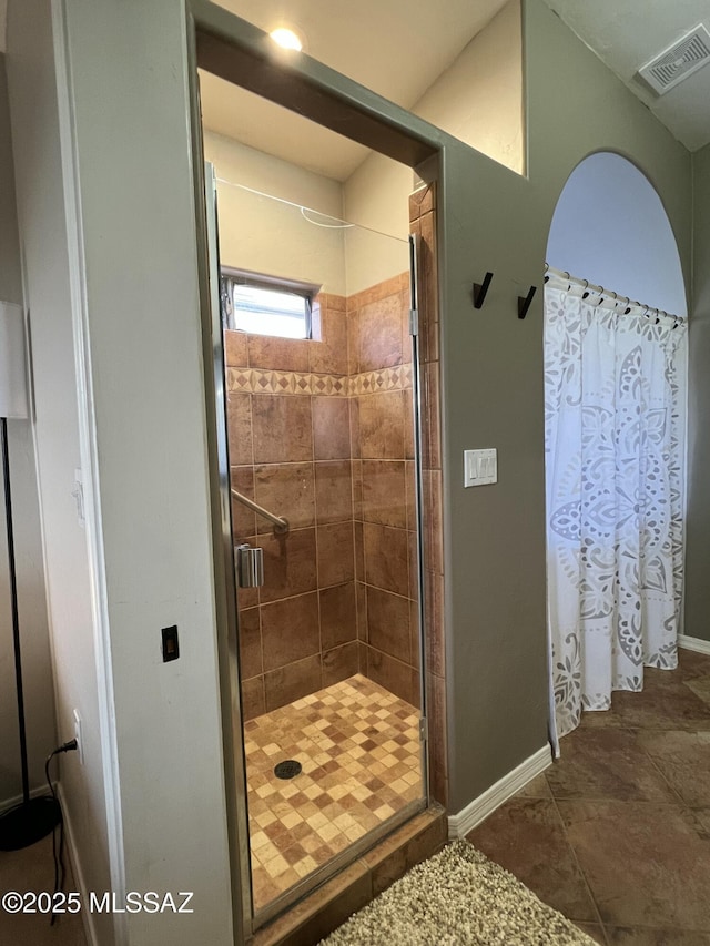 full bathroom featuring baseboards, visible vents, and a shower stall