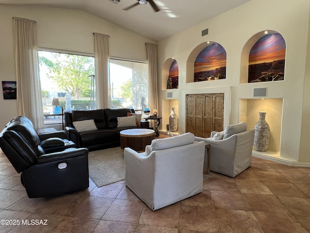 living room featuring baseboards, a ceiling fan, and lofted ceiling