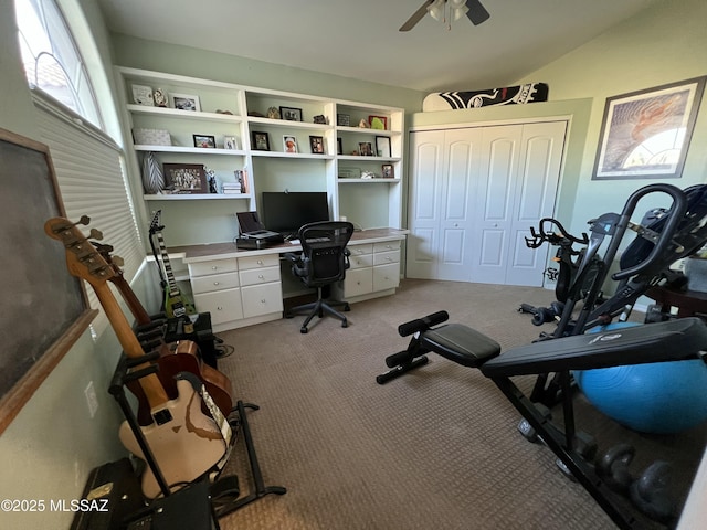 office space featuring ceiling fan, vaulted ceiling, and light colored carpet